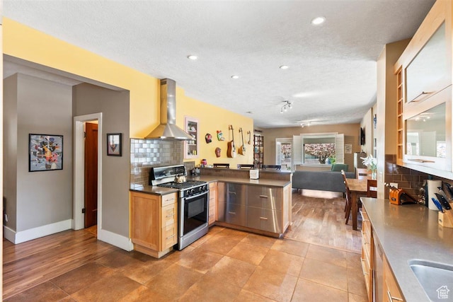 1159 S Windsor St, Salt Lake City, UT 84105 - kitchen with gas stove, open floor plan, a peninsula, island range hood, and tasteful backsplash