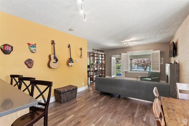 1159 S Windsor St, Salt Lake City, UT 84105 - living area with track lighting, a textured ceiling, wood finished floors, and baseboards