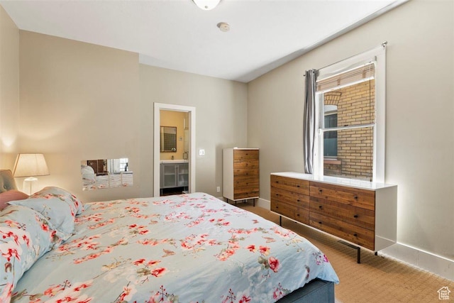 1159 S Windsor St, Salt Lake City, UT 84105 - carpeted bedroom with connected bathroom and baseboards
