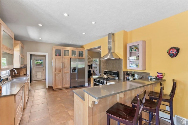 1159 S Windsor St, Salt Lake City, UT 84105 - kitchen with a sink, stainless steel appliances, tasteful backsplash, and wall chimney range hood