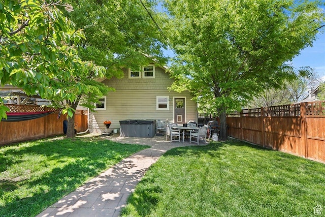 1159 S Windsor St, Salt Lake City, UT 84105 - back of property with a yard, a patio area, a hot tub, and a fenced backyard