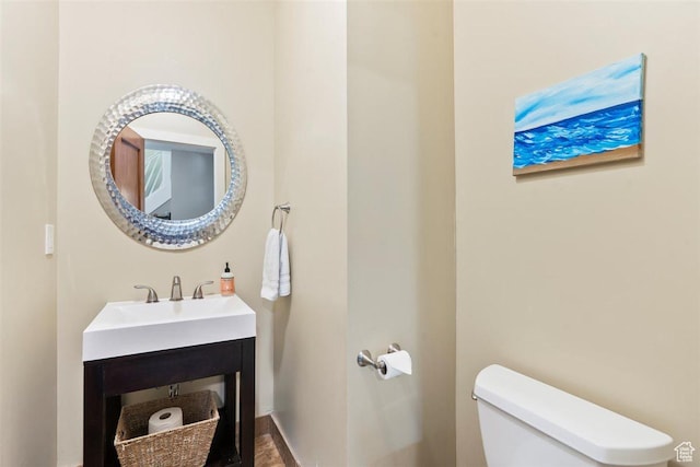 1159 S Windsor St, Salt Lake City, UT 84105 - half bathroom featuring toilet, baseboards, and a sink
