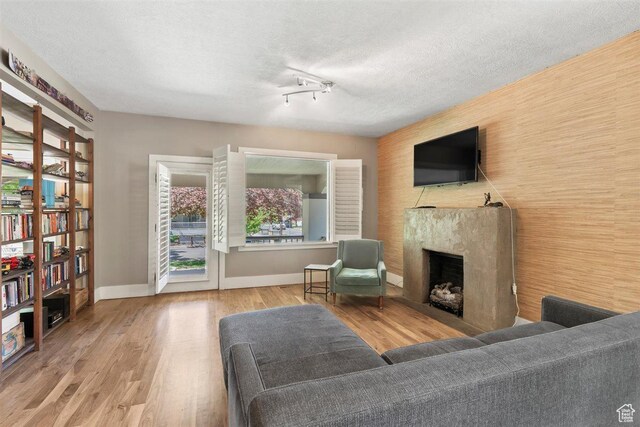 1159 S Windsor St, Salt Lake City, UT 84105 - living area with wood finished floors, a fireplace, baseboards, and a textured ceiling
