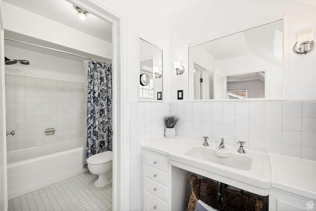 341 E E Blvd, Logan, UT 84321 - bathroom with tile walls, toilet, a sink, tile patterned floors, and shower / bath combo