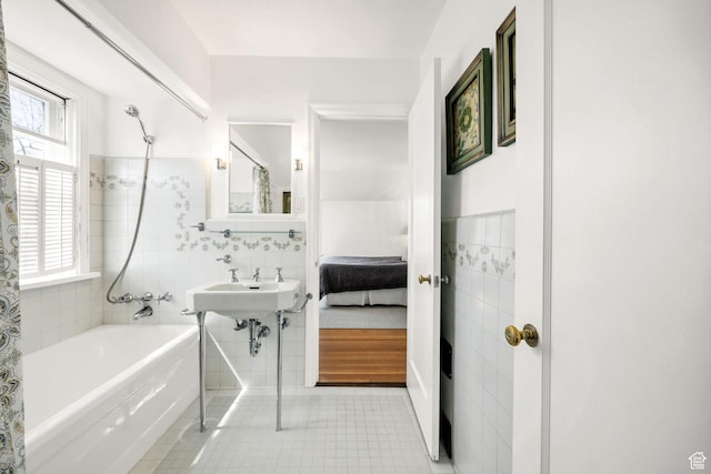 341 E E Blvd, Logan, UT 84321 - bathroom featuring tile walls, shower / bath combination, wainscoting, a sink, and tile patterned floors