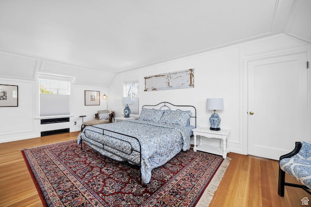 341 E E Blvd, Logan, UT 84321 - bedroom featuring multiple windows, vaulted ceiling, and wood finished floors