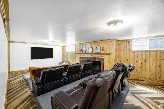 341 E E Blvd, Logan, UT 84321 - cinema room with a fireplace, wood walls, and baseboards
