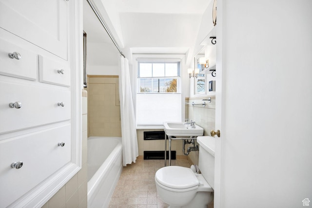 341 E E Blvd, Logan, UT 84321 - full bathroom with a sink, toilet, tile walls, tile patterned floors, and shower / tub combo