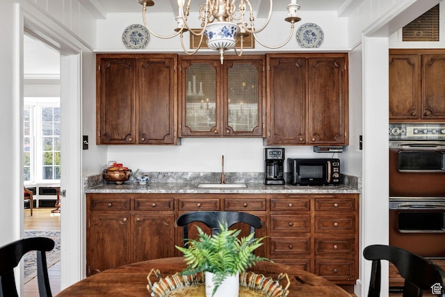341 E E Blvd, Logan, UT 84321 - bar with a sink, visible vents, multiple ovens, a chandelier, and black microwave