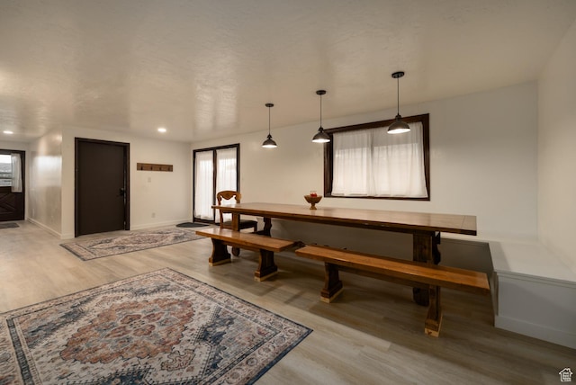 dining area featuring wood finished floors and baseboards