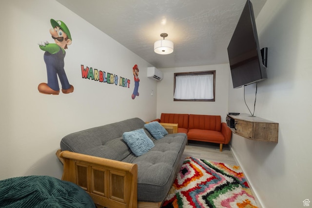 living room featuring an AC wall unit and wood finished floors