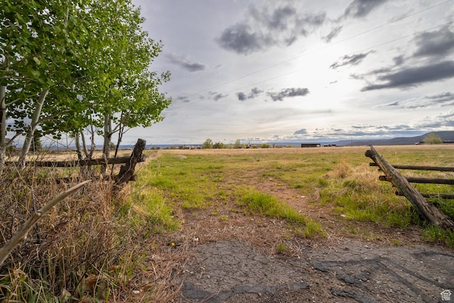 view of yard with a rural view and fence