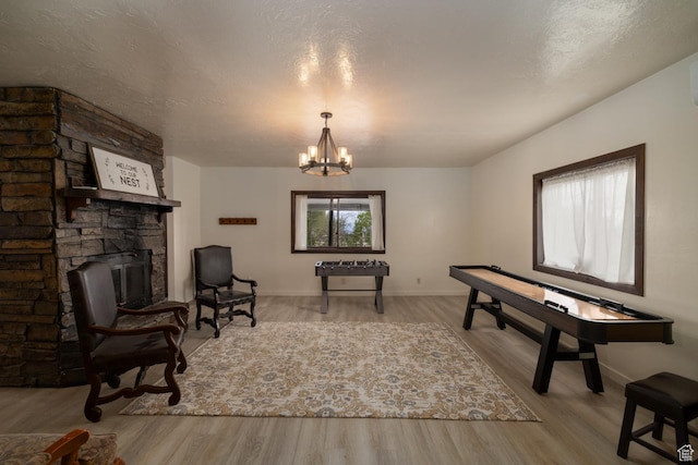 sitting room featuring wood finished floors, a chandelier, and baseboards