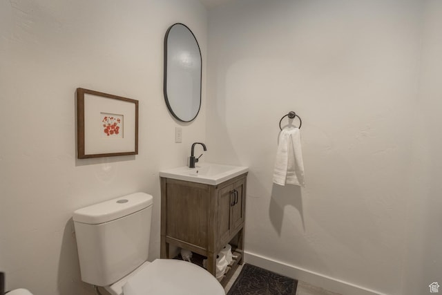 half bath featuring toilet and vanity