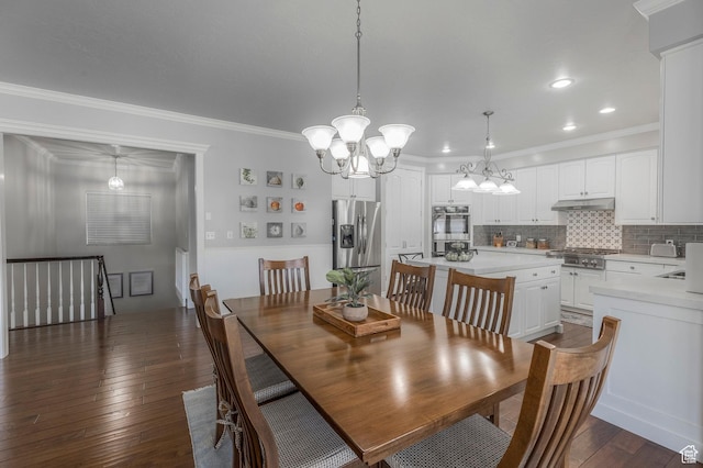 dining room featuring recessed lighting, an inviting chandelier, ornamental molding, and dark wood-style floors