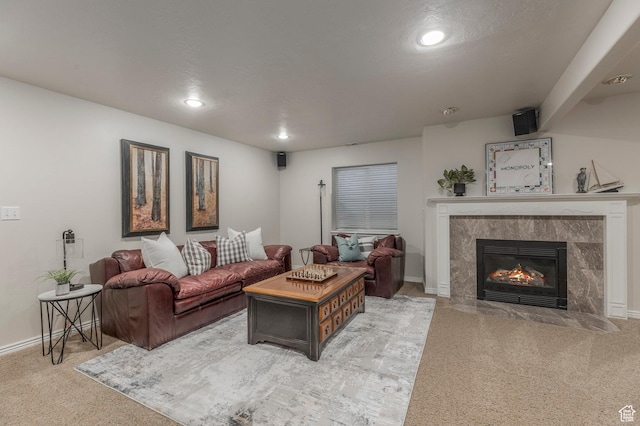 living area with a fireplace, light colored carpet, baseboards, and recessed lighting