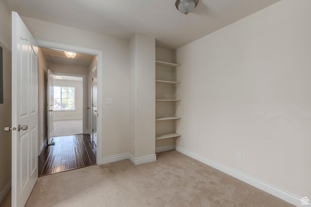 interior space featuring baseboards and carpet floors