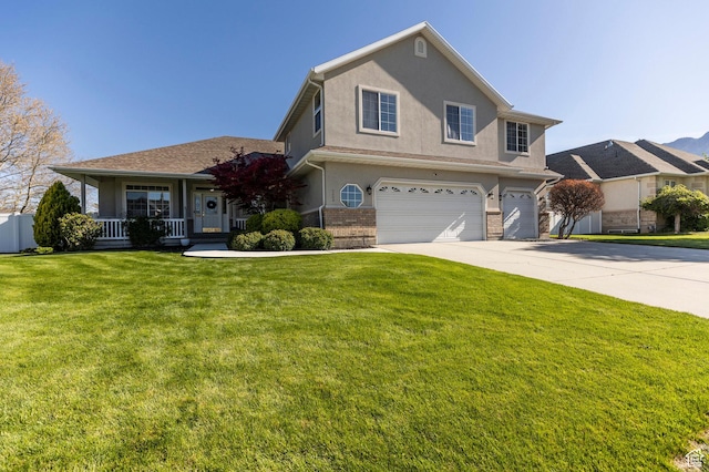 traditional-style house featuring an attached garage, covered porch, concrete driveway, a front yard, and brick siding