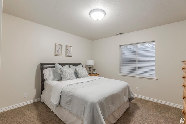 carpeted bedroom with visible vents and baseboards