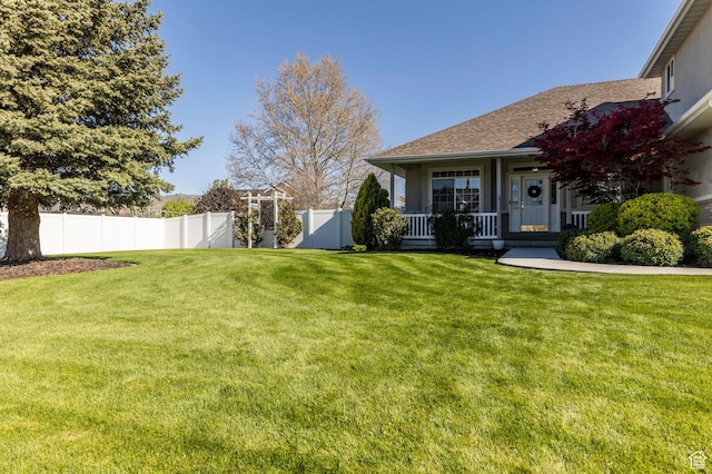view of yard featuring a porch and fence