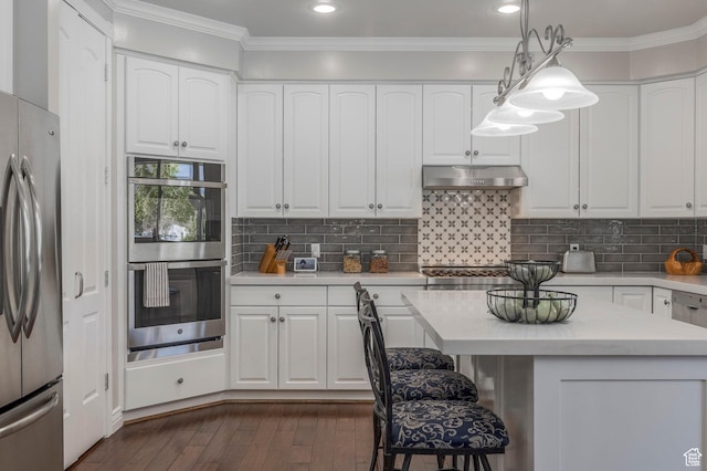 kitchen featuring light countertops, stainless steel appliances, white cabinets, and under cabinet range hood
