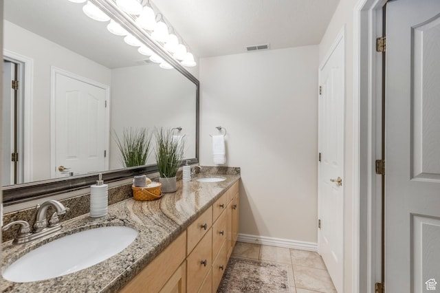 bathroom with double vanity, visible vents, tile patterned flooring, and a sink
