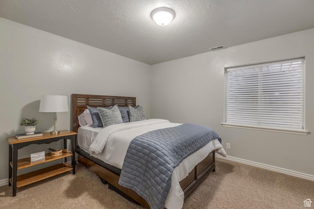 bedroom featuring baseboards, visible vents, and carpet