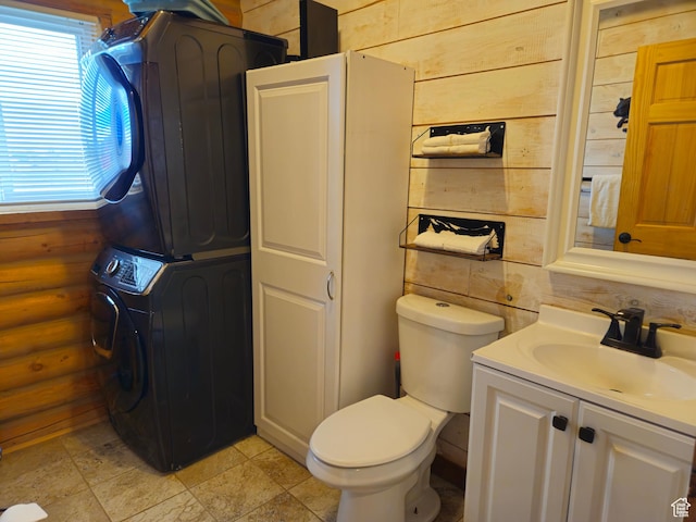 50 E 200 S, Saint Charles, ID 83272 - bathroom featuring stacked washer and clothes dryer, toilet, vanity, and stone finish flooring