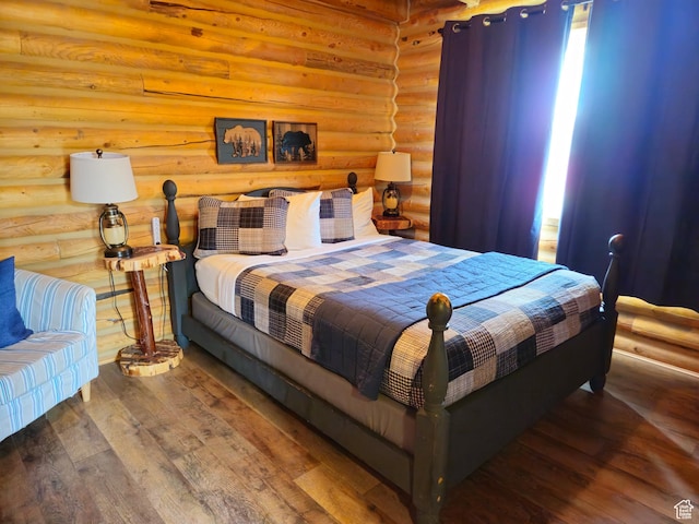 50 E 200 S, Saint Charles, ID 83272 - bedroom featuring log walls and hardwood / wood-style flooring