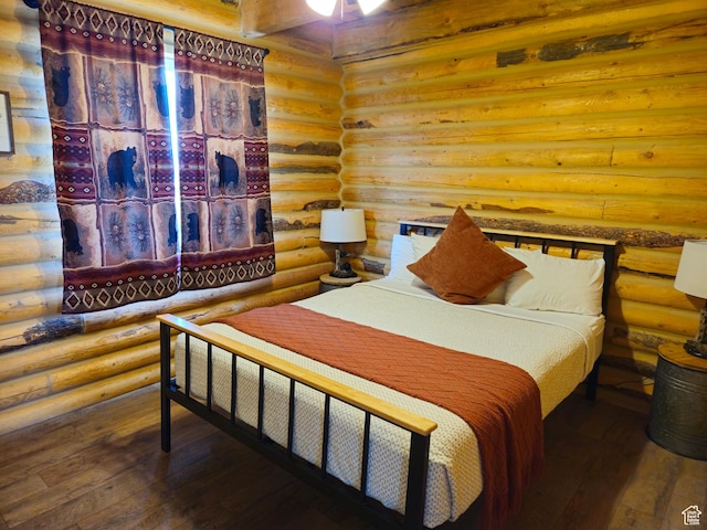 50 E 200 S, Saint Charles, ID 83272 - bedroom with log walls and hardwood / wood-style floors