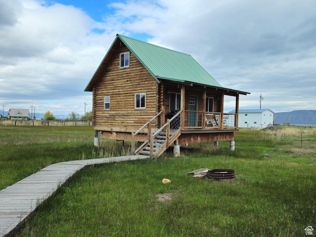 50 E 200 S, Saint Charles, ID 83272 - view of front of home featuring log exterior, a fire pit, and metal roof