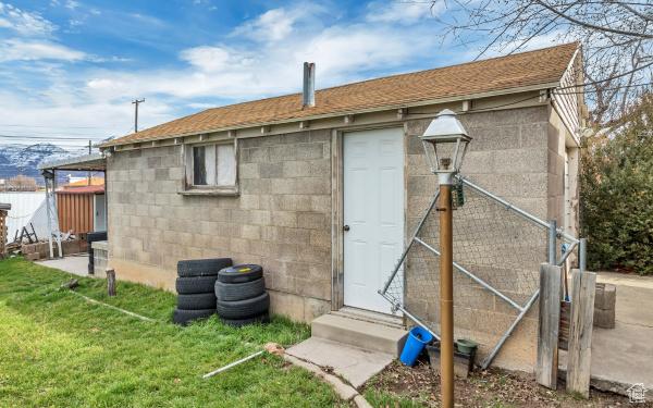 exterior space featuring a yard, entry steps, and concrete block siding