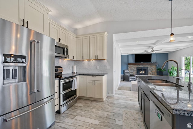 11549 S Equestrian Dr W, South Jordan, UT 84095 - kitchen featuring a ceiling fan, a sink, stainless steel appliances, lofted ceiling with beams, and decorative backsplash