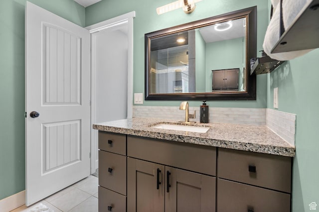 11549 S Equestrian Dr W, South Jordan, UT 84095 - bathroom featuring tile patterned floors, baseboards, vanity, and backsplash