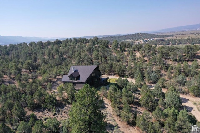 aerial view featuring a mountain view and a view of trees