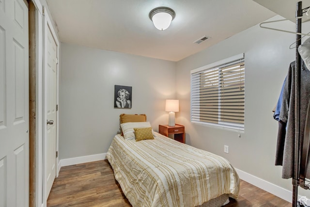 883 W 660 S, Tooele, UT 84074 - bedroom featuring baseboards, visible vents, and wood finished floors
