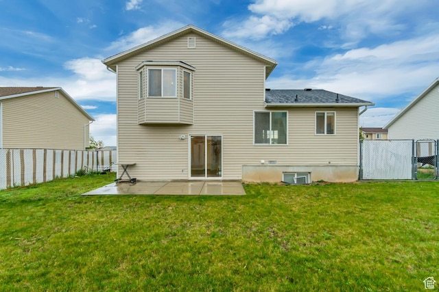 883 W 660 S, Tooele, UT 84074 - rear view of house featuring a yard, a patio, a shingled roof, and a fenced backyard