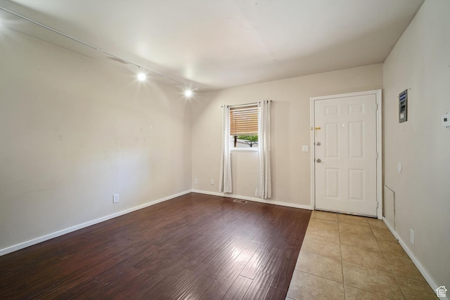 370 E Scott Ave, South Salt Lake, UT 84115 - unfurnished room with rail lighting, wood finished floors, and baseboards