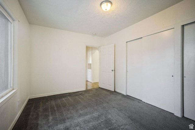 370 E Scott Ave, South Salt Lake, UT 84115 - unfurnished bedroom with carpet, a textured ceiling, and baseboards