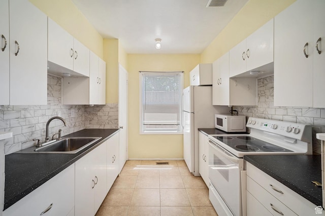 370 E Scott Ave, South Salt Lake, UT 84115 - kitchen featuring white appliances, a sink, white cabinetry, backsplash, and dark countertops