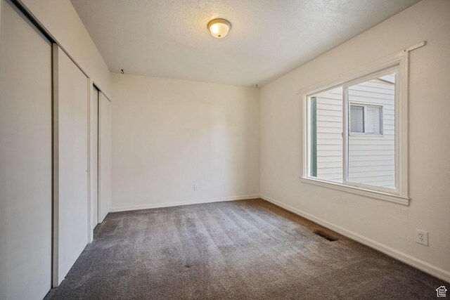 370 E Scott Ave, South Salt Lake, UT 84115 - unfurnished bedroom featuring carpet flooring, baseboards, a closet, and visible vents
