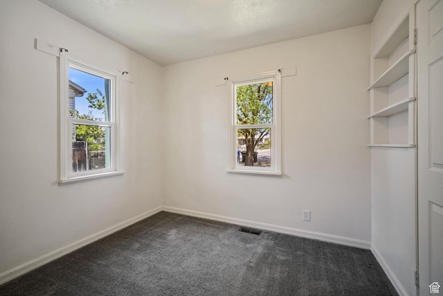 370 E Scott Ave, South Salt Lake, UT 84115 - empty room with visible vents, baseboards, and dark colored carpet