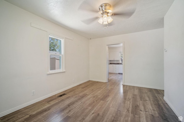 370 E Scott Ave, South Salt Lake, UT 84115 - unfurnished room with visible vents, wood finished floors, baseboards, and ceiling fan