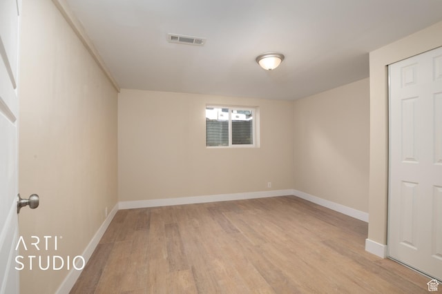 interior space featuring baseboards, light wood-style flooring, and visible vents