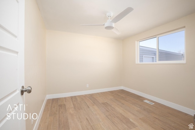 empty room with light wood finished floors, ceiling fan, and baseboards
