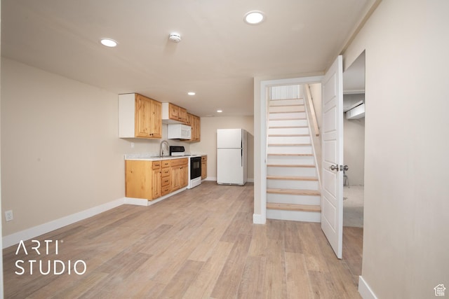 kitchen with white appliances, light countertops, baseboards, and recessed lighting