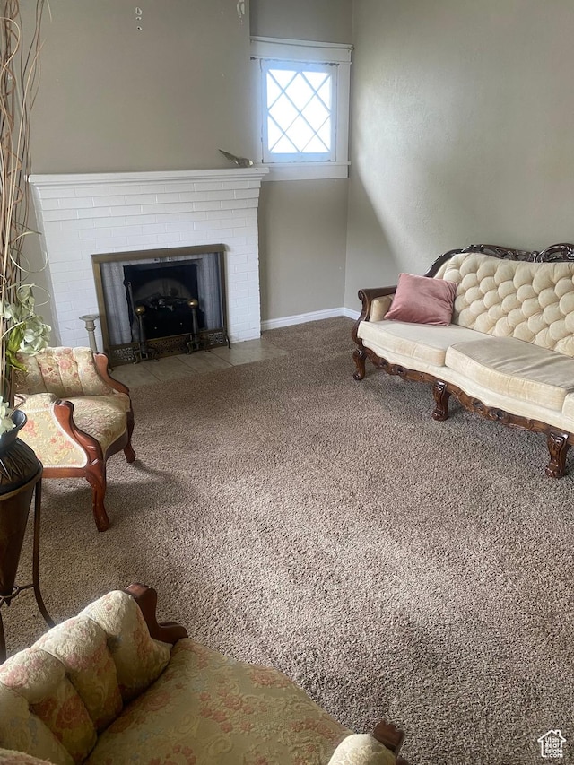 living area featuring a fireplace, carpet floors, and baseboards