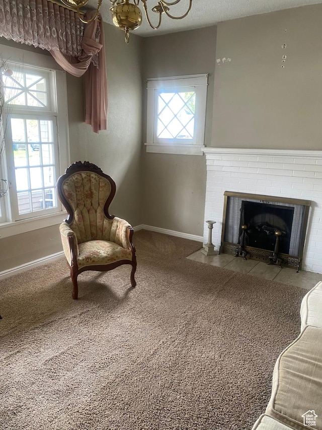sitting room with baseboards, a brick fireplace, and carpet