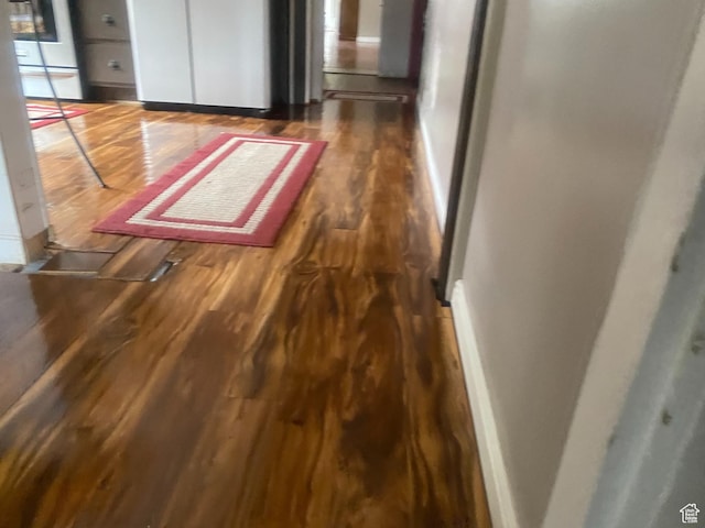 interior space featuring baseboards and wood finished floors
