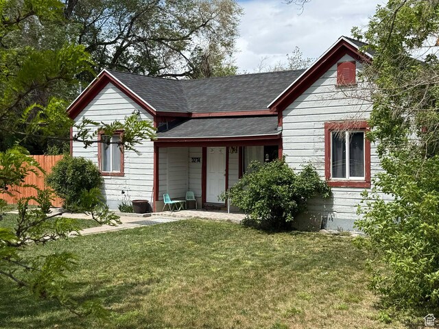 3274 W 3100 S, West Valley City, UT 84119 - back of house featuring a yard, roof with shingles, and fence